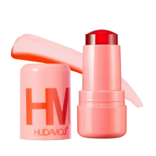 HUDA MOJI colorful lipstick collection featuring pink, coral, and red lipstick tubes with matching product packaging arranged on a soft pastel background.