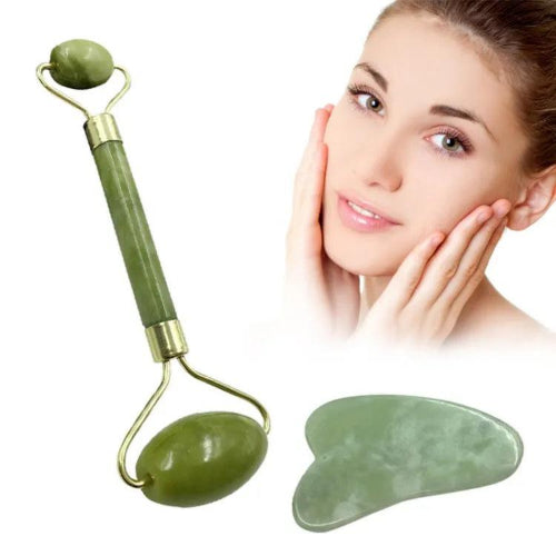 Green jade facial roller and heart-shaped gua sha stone for facial massage and skincare on a clean white background.