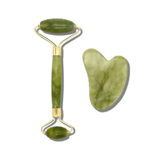 Green jade facial roller and heart-shaped gua sha stone for facial massage and skincare on a clean white background.