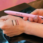 4-in-1 pink makeup pen for eyeliner, eyebrow, lip liner, and highlighter with multiple color swatches.