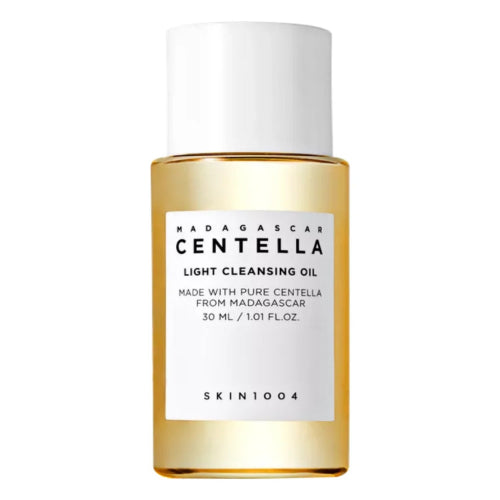 SKIN1004 Madagascar Centella Light Cleansing Oil bottle with pump and matching product box on a softly lit neutral background.