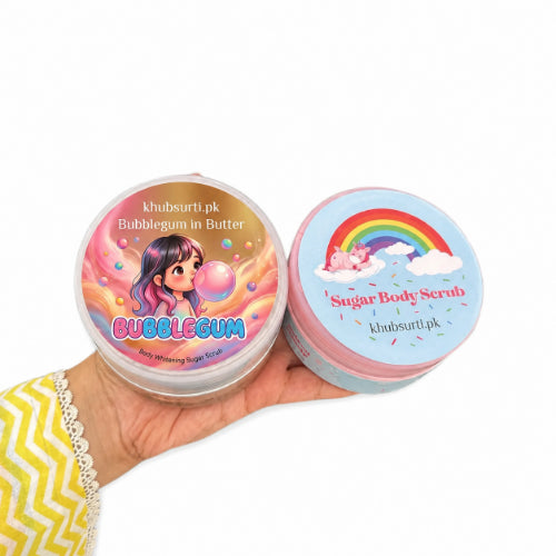 Two colorful sugar body scrub containers held in a hand against a clean white background, featuring Bubblegum and Sugar Body Scrub labels with playful illustrated designs.